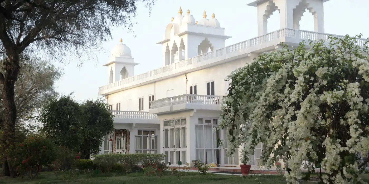 Savista Retreat, Jaipur: Elegant white facade of a luxury Rajasthani villa.