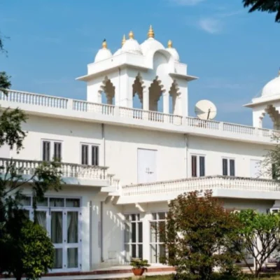 White heritage-style building with domes and arched windows, reflecting elegant traditional architecture and symmetry