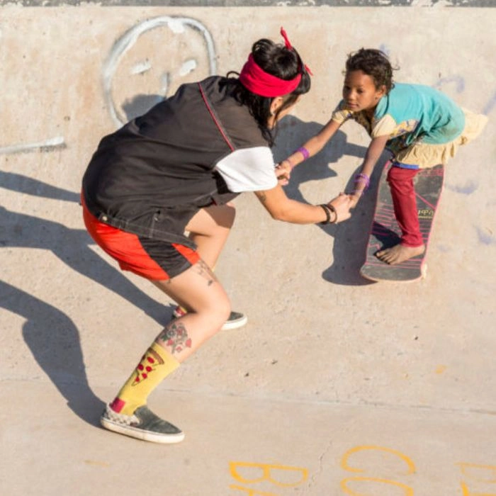 Skateboarder riding confidently on a sunny day, capturing a playful, grounded moment full of motion and street style