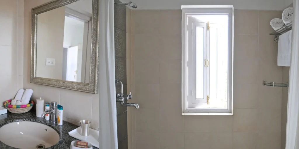 Modern bathroom with mirror, shower, and window