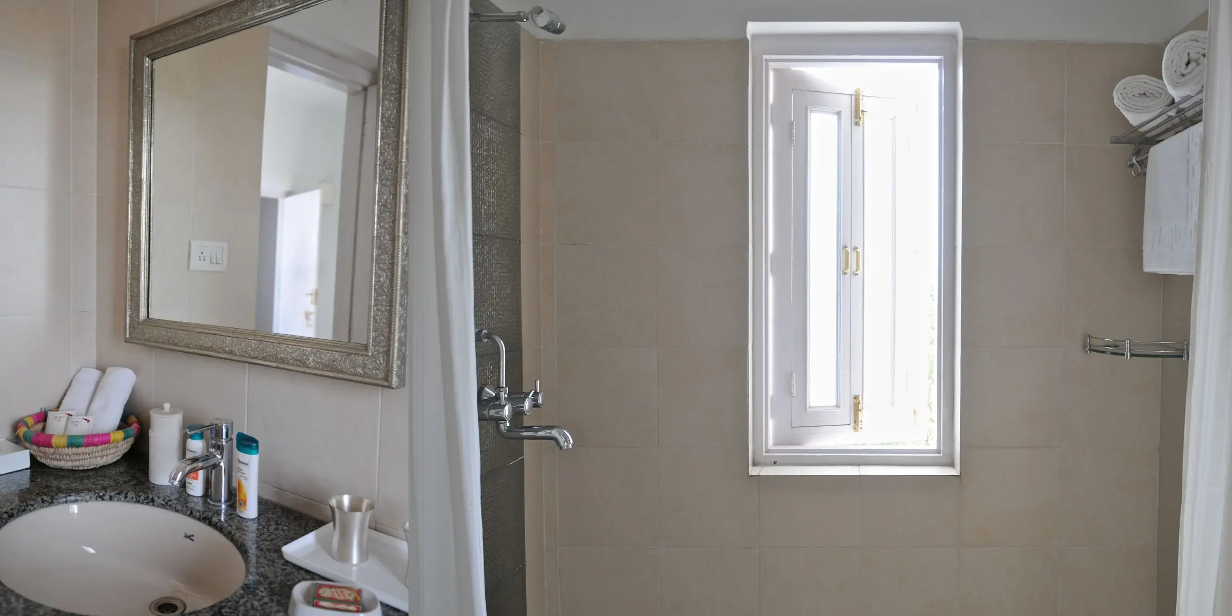 Modern bathroom with mirror, shower, and window