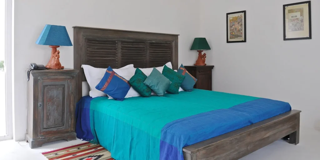 Bedroom with colorful pillows and wooden furniture