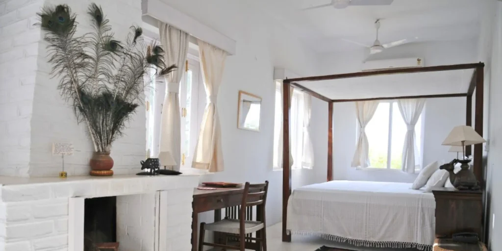 Cozy bedroom with peacock feathers and white curtains