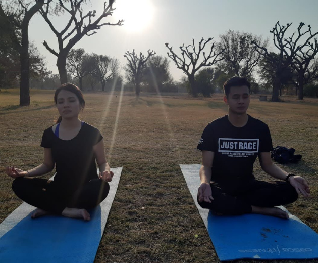 Two people doing yoga in open space