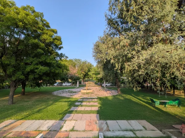 Expansive green lawns and sun-dappled courtyards at the 12-acre Savista Retreat countryside estate.