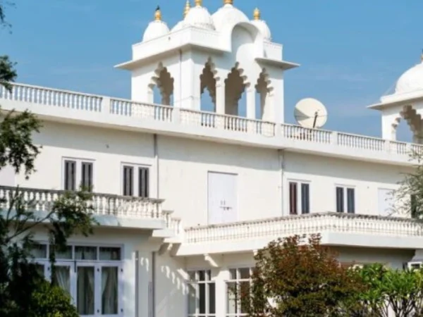 White heritage-style building with domes and arched windows, reflecting elegant traditional architecture and symmetry