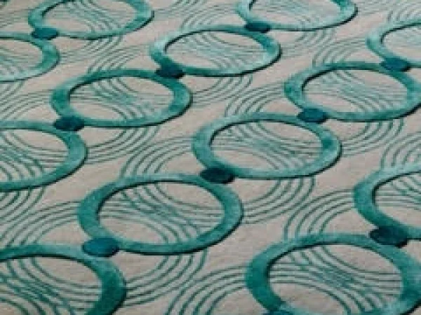 Turquoise interlocking circles create a rhythmic design on a light background.
