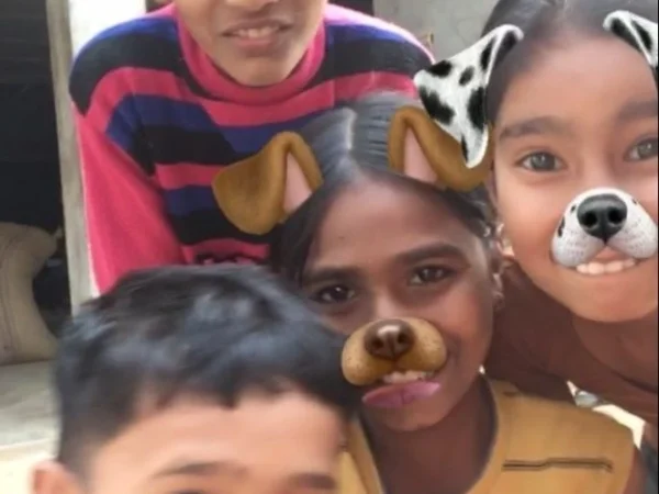 Kids in Jaipur, Rajasthan, using dog filter for selfie at Savista Retreat, happily posing.